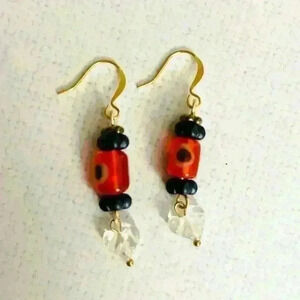 Handmade orange evil eye glass bead dangle earrings with carved quartz hearts